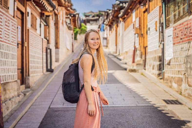 a young adult exploring traditional neighbourhood in Seoul