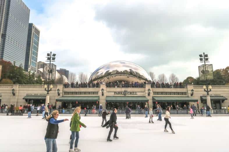 families and teenagers ice skating in Chicago in the city centre