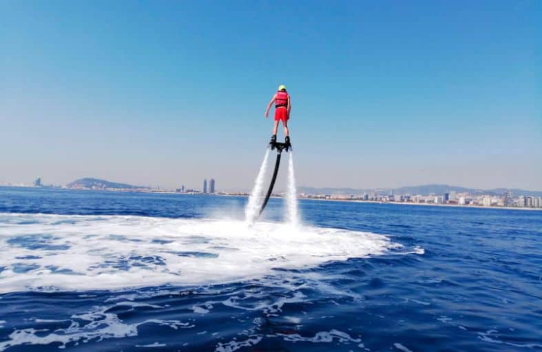 Barcelona with teenagers having fun on the water with a flyboard