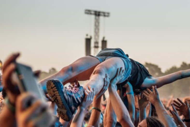 A person crowd surfing at Pol’and’Rock Festival. Festivals in Poland are popular for all ages.