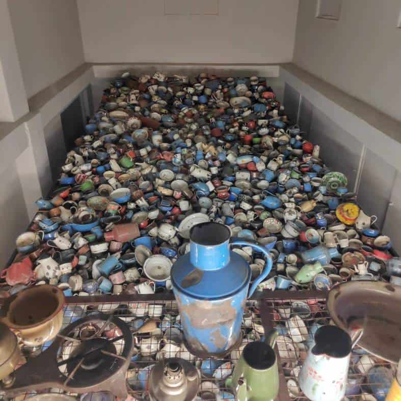 Personal belongings such as cups and jugs that belonged to prisoners at Auschwitz