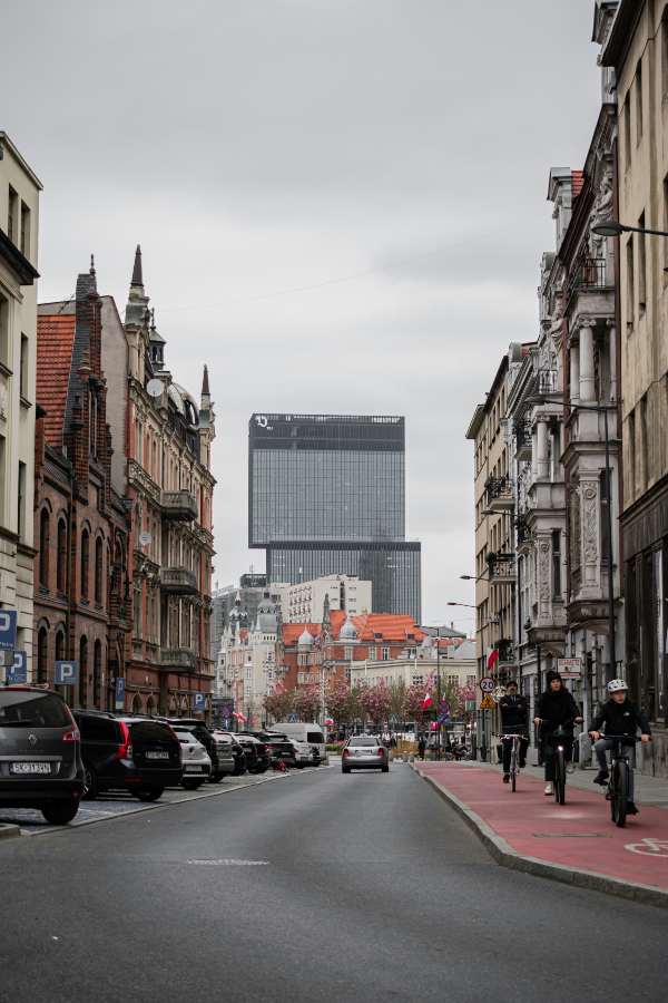 a street with cars and people on bikes