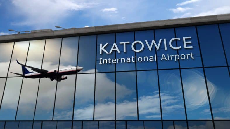Finding airports close to Auschwitz will help you plan your trip. The glass windows of the Katowice international airport reflect a plane about to land