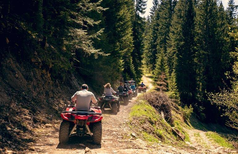 people on a quad bike tour through the forest in Rovaniemi