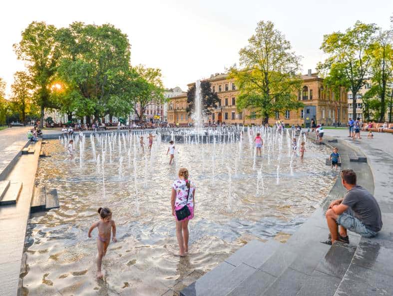 kids playing in a fountain in Lublin in summer
