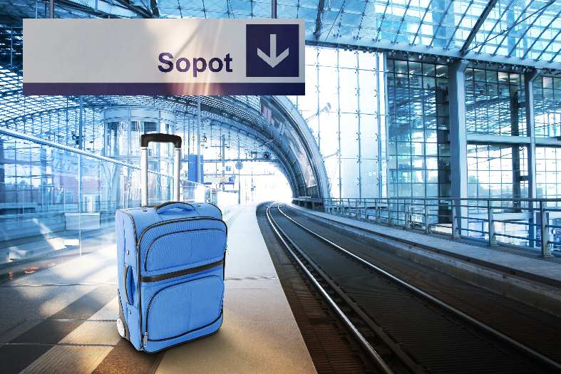 A train platform in Poland with a sign for Sopot